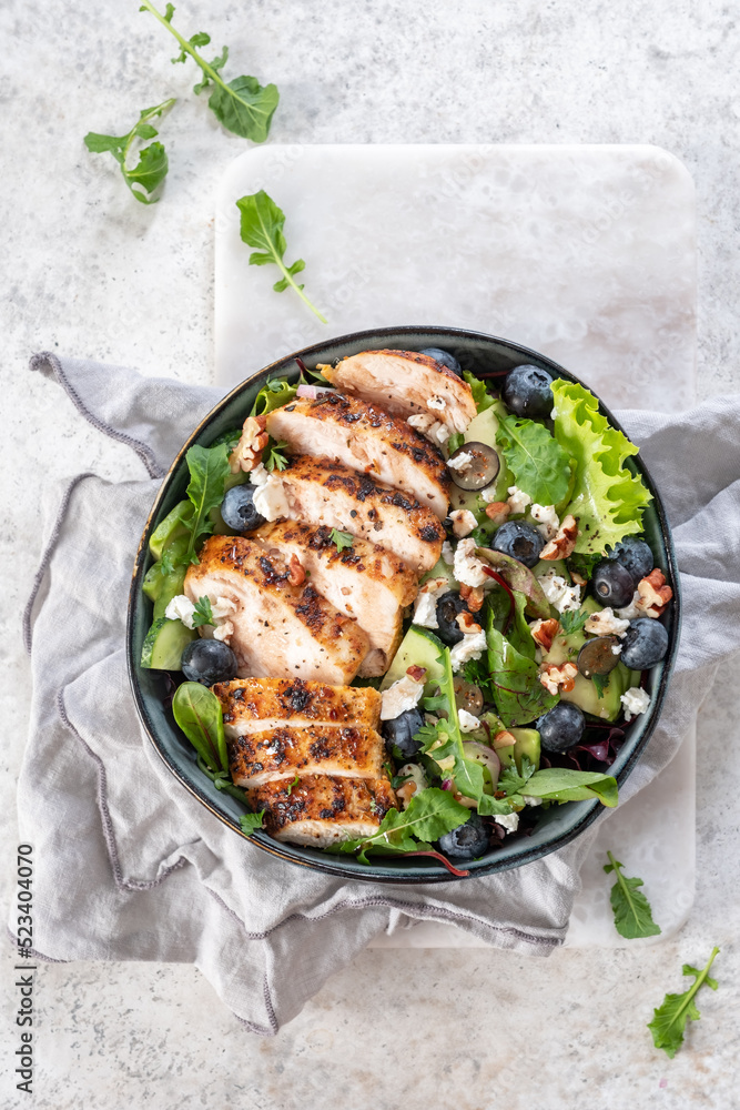 Grilled chicken breast, fillet and fresh vegetable salad of lettuce, arugula, spinach, avocado, onion and pecan nut with blueberry. Summer salad, healthy eating. Fresh healthy food. Grilled chicken breast, fillet and fresh vegetable salad of lettuce, arugula, spinach, avocado, onion and pecan nut with blueberry. Summer salad, healthy eating. Fresh healthy food.