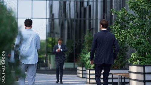 Diverse corporate people walking office building in suit. Businesspeople concept