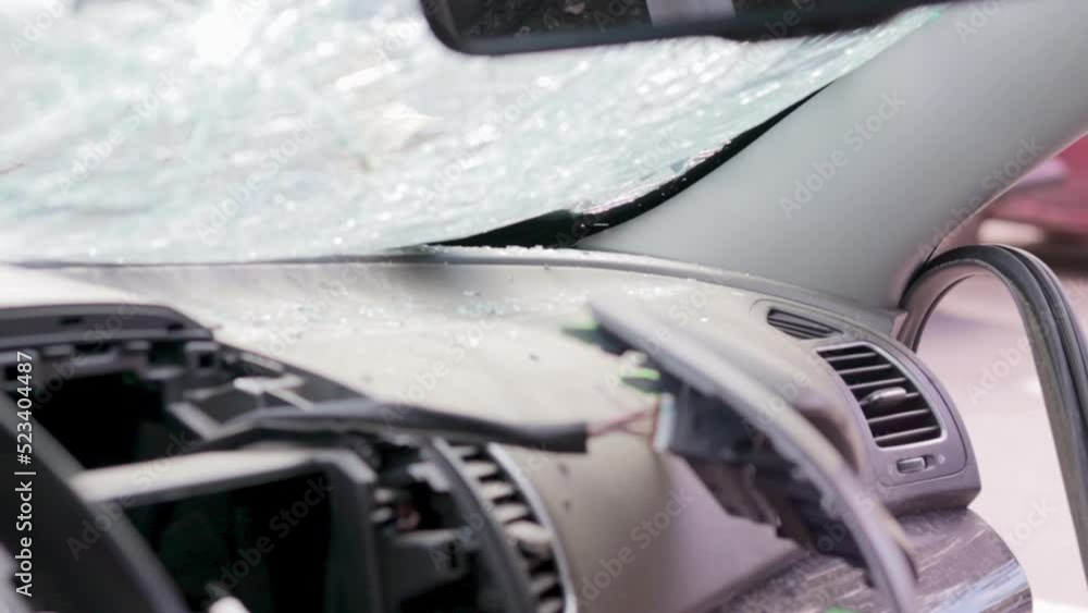 Cracked car windshield after an accident. Close-up of a wrecked vehicle after a collision with a pedestrian or car accident. Damaged vehicle. Road safety, car insurance. View from inside the cabin. Cracked car windshield after an accident. Close-up of a wrecked vehicle after a collision with a pedestrian or car accident. Damaged vehicle. Road safety, car insurance. View from inside the cabin.