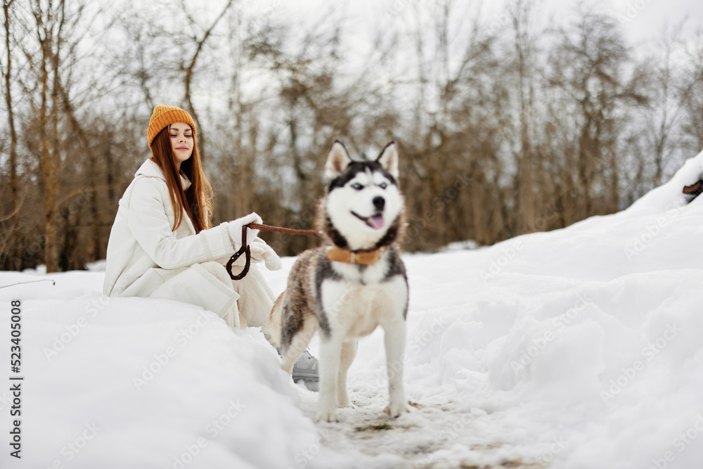 young woman outdoors in a field in winter walking with a dog Lifestyle young woman outdoors in a field in winter walking with a dog Lifestyle