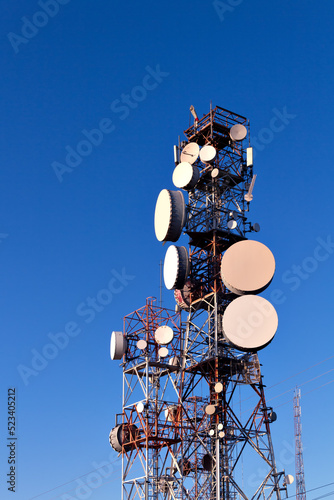 Transmission and telecommunications towers with blue sky in the background