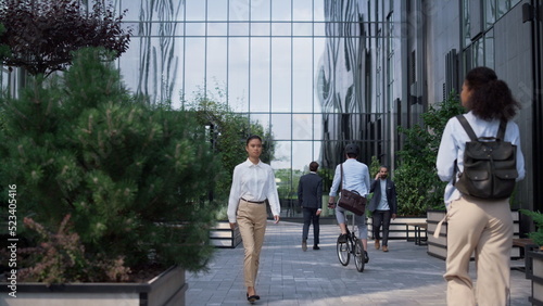 Corporate people going to workplaces in morning at modern glass office building. © stockbusters