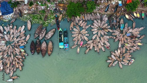 Wooden boats are arranged in floral shapes in Buriganga river, Sadarghat, Dhaka, Bangladesh. photo