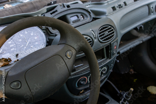 A steering wheel with dashboard of damaged car