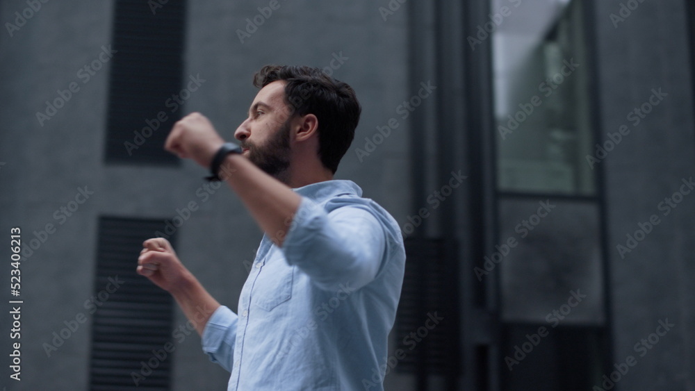Happy bearded man celebrating victory in downtown area. Energetic businessman Happy bearded man celebrating victory in downtown area. Energetic businessman