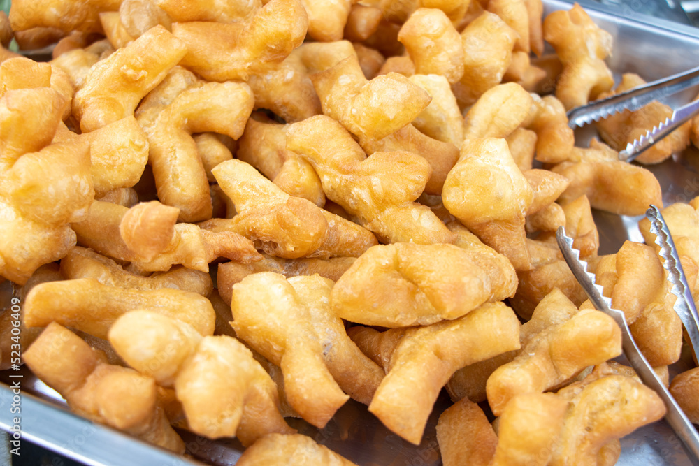 The offer of a deep-fried dough stick at Thai market, close up. The offer of a deep-fried dough stick at Thai market, close up.