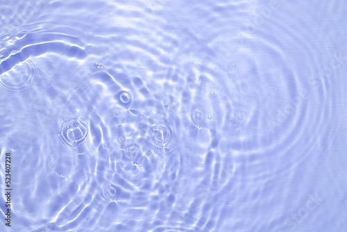 Closeup of purple water surface texture with splashes and bubbles