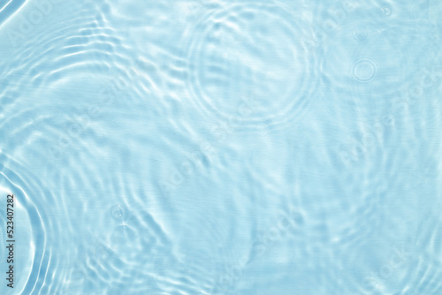 Fototapeta Naklejka Na Ścianę i Meble -  Closeup of blue water surface texture with splashes and bubbles