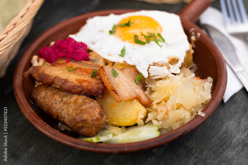 Breakfast of scrambled eggs with fried bacon and potatoes Breakfast of scrambled eggs with fried bacon and potatoes
