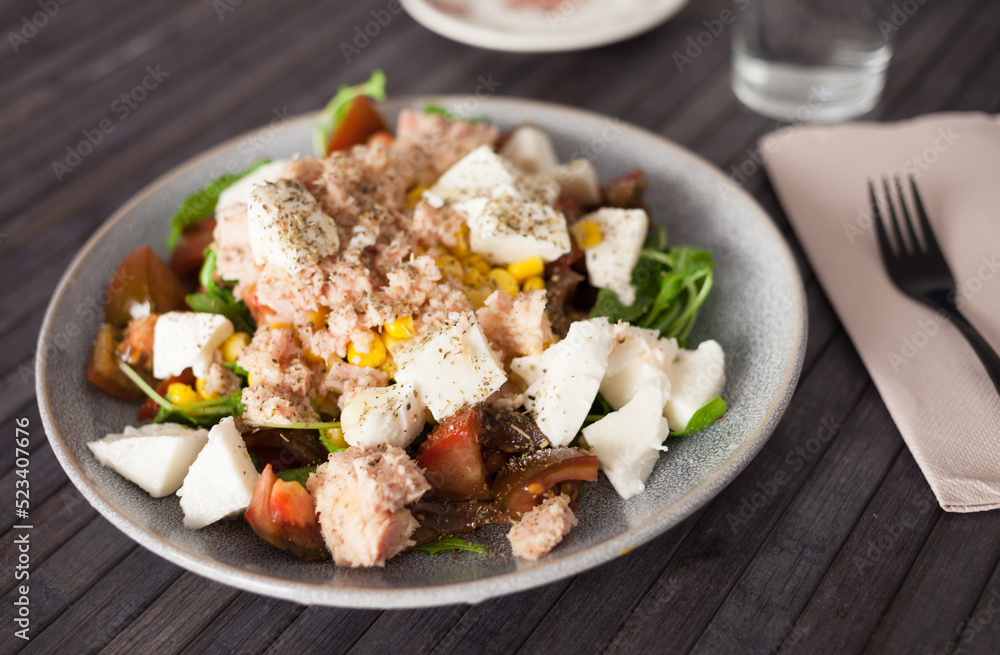 Plate of salad with tuna, corn, tomatoes and arugula Plate of salad with tuna, corn, tomatoes and arugula