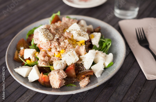 Plate of salad with tuna, corn, tomatoes and arugula