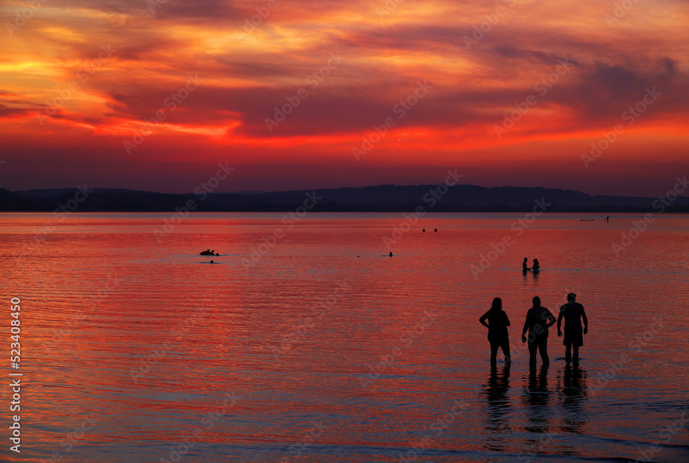 Tourists at Sempach Lake in Switzerland, Europe. Sunset light.