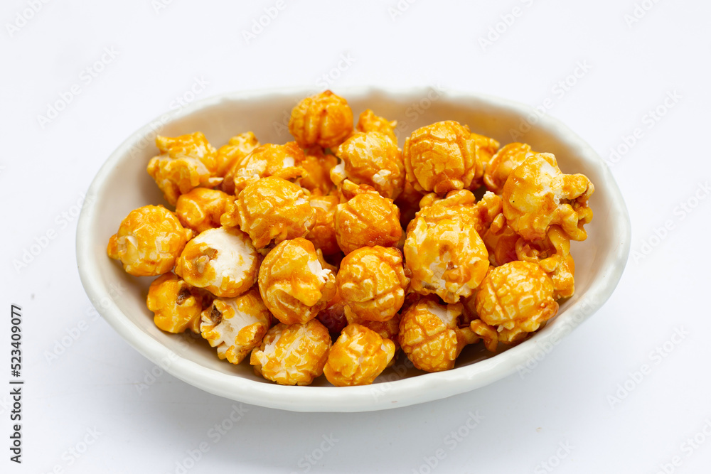Honey caramel popcorn on white background.