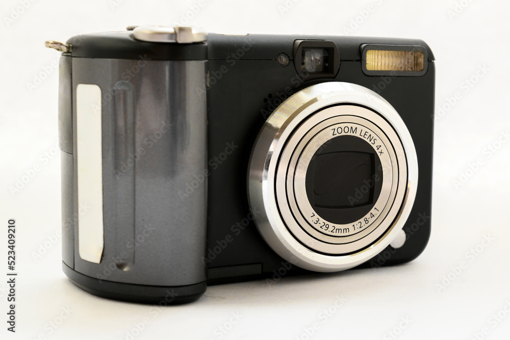 compact digital camera in black with a gray zoom lens on a white background close-up compact digital camera in black with a gray zoom lens on a white background close-up