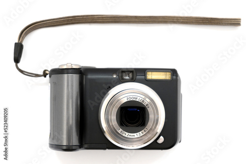 compact digital camera in black with a gray zoom lens on a white background close-up