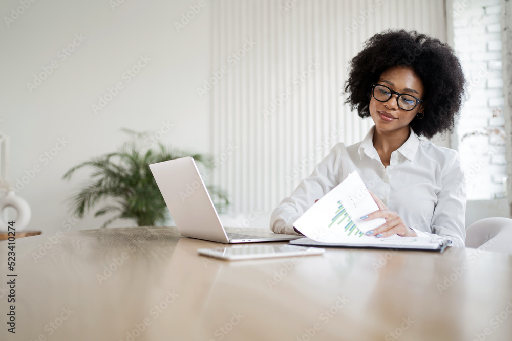 A female secretary makes an online report to the workplace in the office, uses a computer A female secretary makes an online report to the workplace in the office, uses a computer