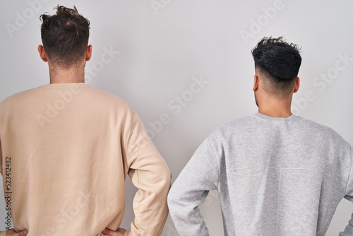 Ταπετσαρία Young homosexual couple standing over white background standing backwards lookin