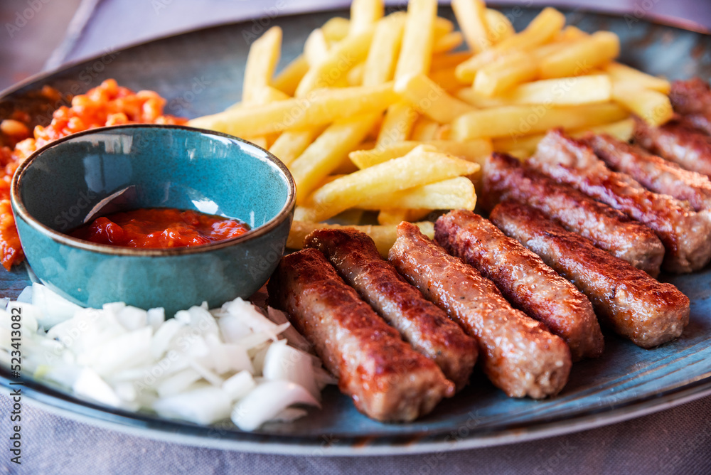 Traditional Cevapcici, ground meat rolls with french fries. Porec, Croatia.
