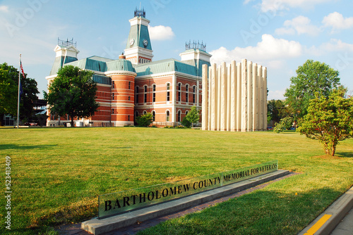 The grounds of the Bartholomew County Courthouse in Columbus, Indiana, hosts the judicial building and a modern Veterans Memorial photo