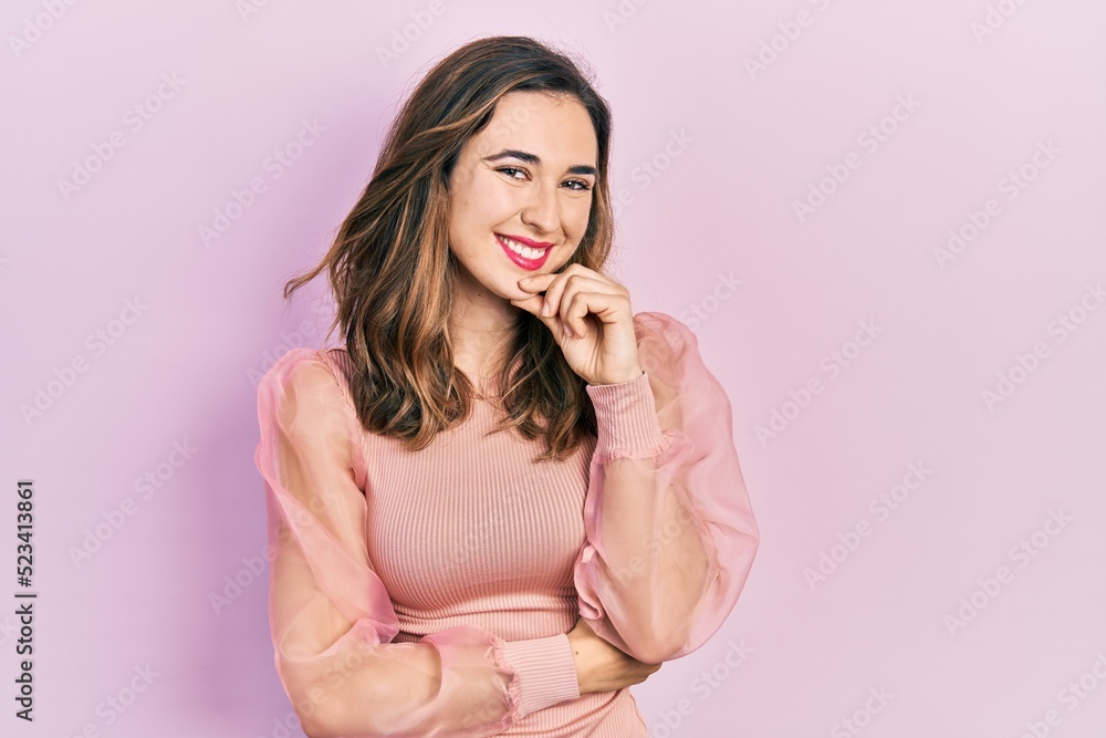 Young hispanic girl wearing casual clothes looking confident at the camera with smile with crossed arms and hand raised on chin. thinking positive. Young hispanic girl wearing casual clothes looking confident at the camera with smile with crossed arms and hand raised on chin. thinking positive.