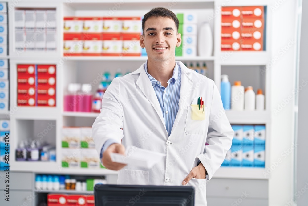 Young hispanic man pharmacist smiling confident holding prescription at pharmacy Young hispanic man pharmacist smiling confident holding prescription at pharmacy