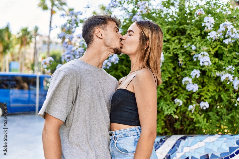 Young hispanic couple kissing and hugging standing at the city. Young hispanic couple kissing and hugging standing at the city.