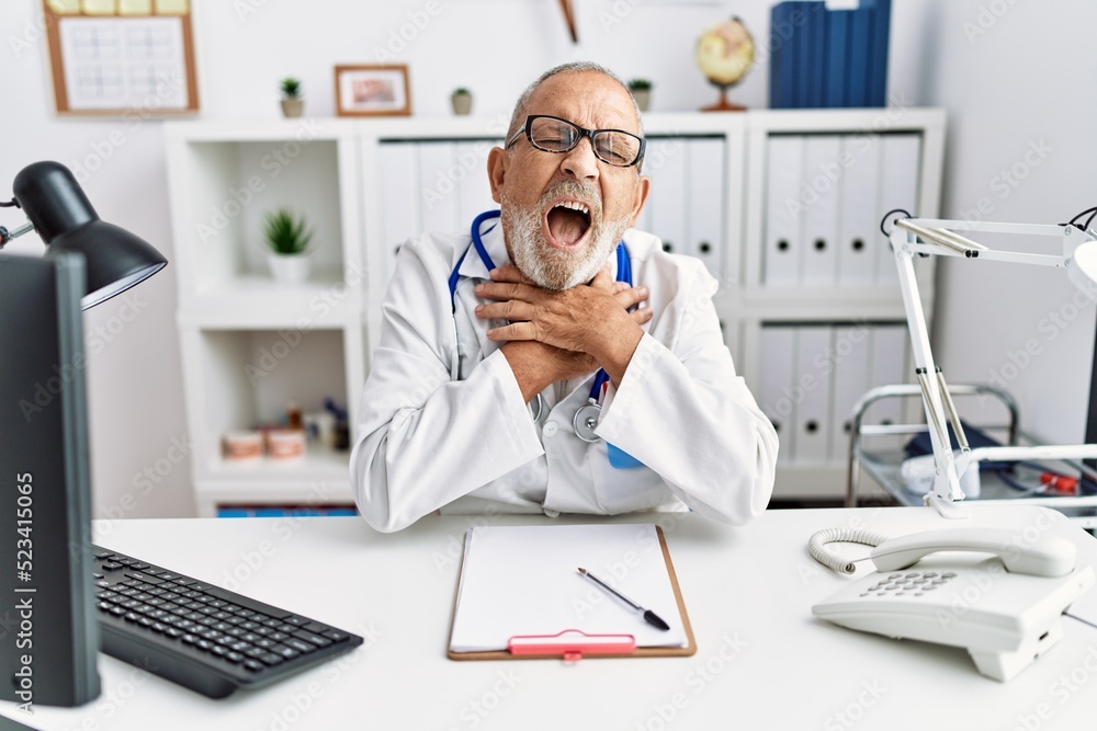 Mature doctor man at the clinic shouting and suffocate because painful strangle. health problem. asphyxiate and suicide concept. Mature doctor man at the clinic shouting and suffocate because painful strangle. health problem. asphyxiate and suicide concept.