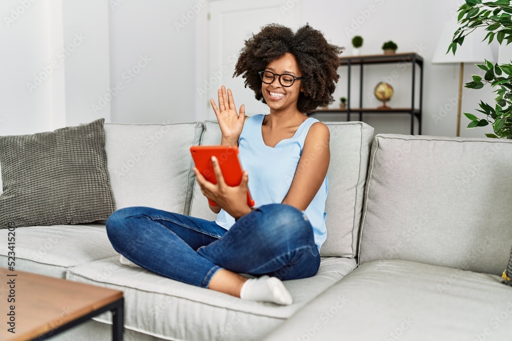 Young african american woman smiling confident using touchpad at home Young african american woman smiling confident using touchpad at home