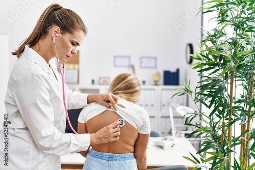 Принти на полотні Woman and girl pediatrician and patient auscultating having medical consultation