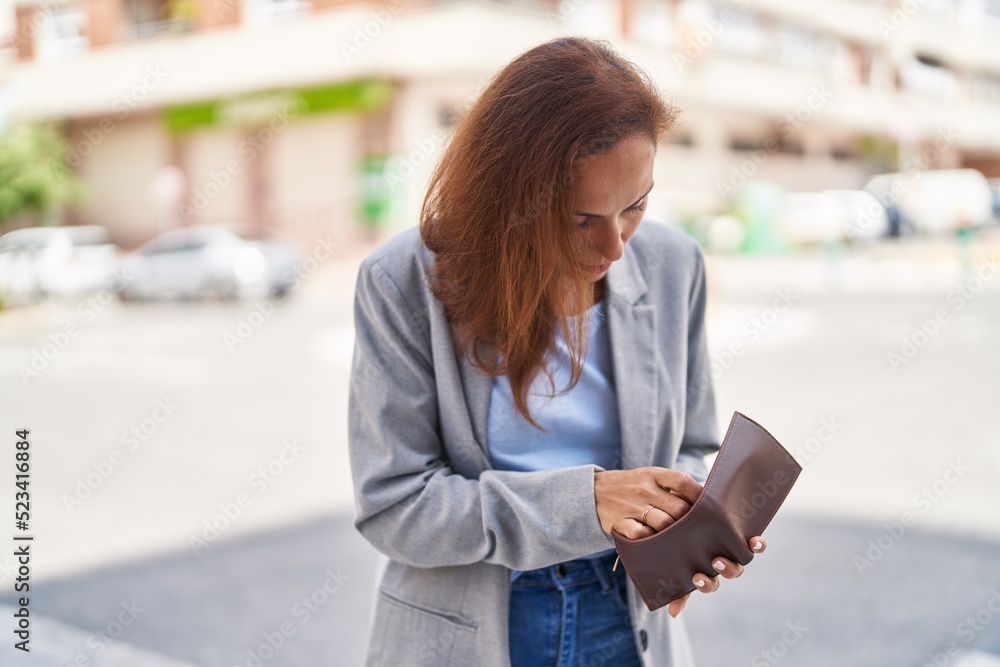 Young woman executive holding empty wallet at street Young woman executive holding empty wallet at street