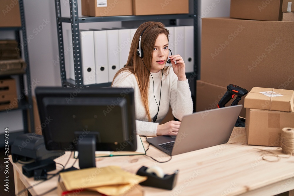 Young blonde woman ecommerce call center agent working at office Young blonde woman ecommerce call center agent working at office