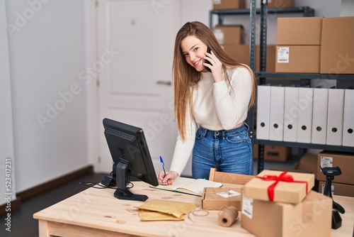 Young blonde woman ecommerce business worker talking on the smartphone at office © Krakenimages.com