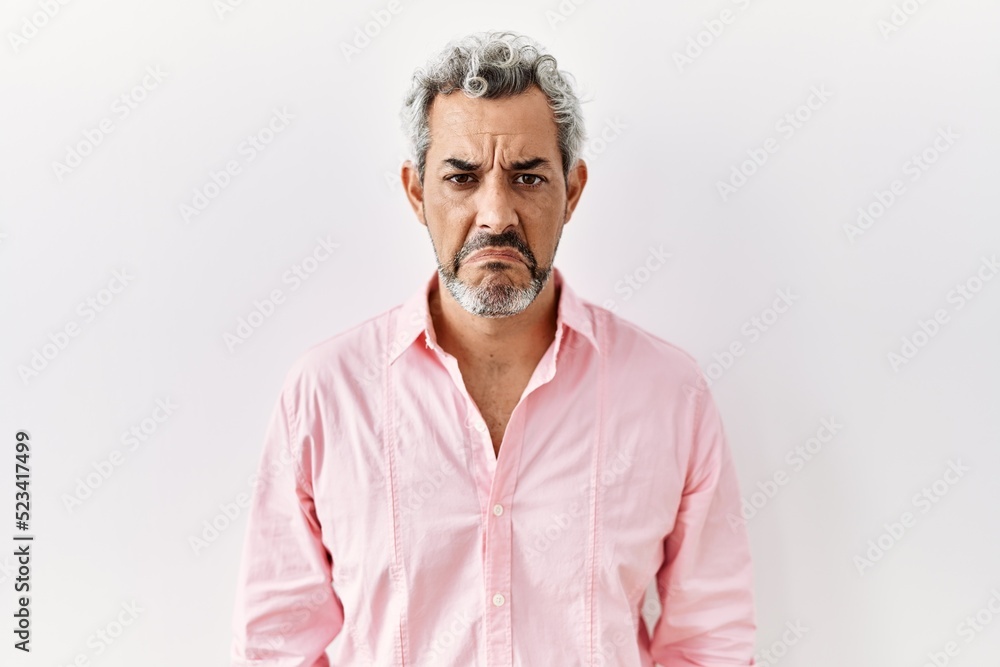 Obraz premium Middle age hispanic man standing over isolated background depressed and worry for distress, crying angry and afraid. sad expression.