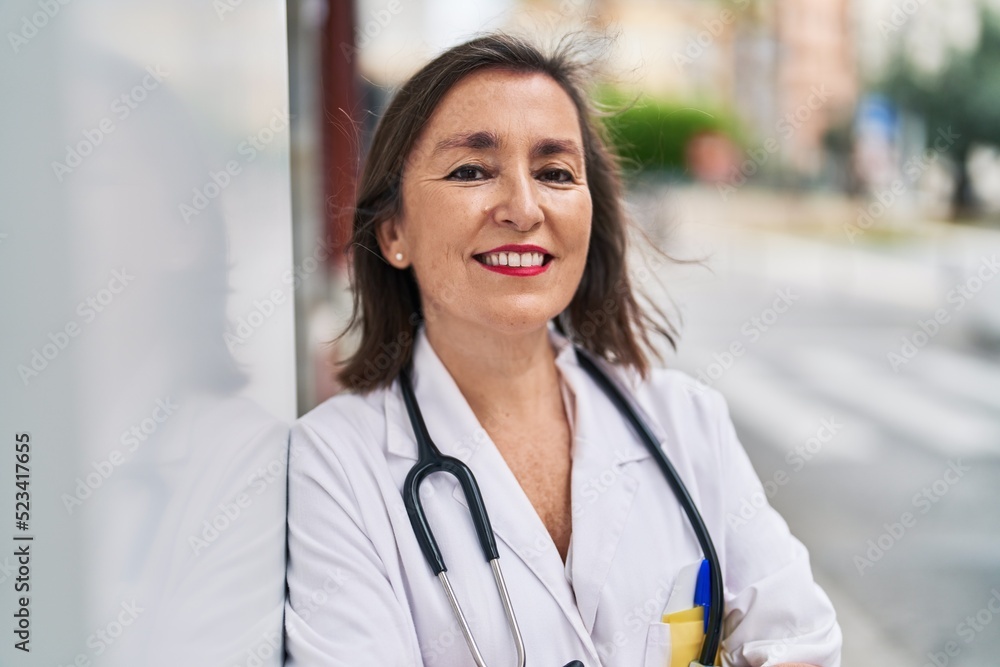 Middle age woman wearing doctor uniform smiling confident standing at street Middle age woman wearing doctor uniform smiling confident standing at street