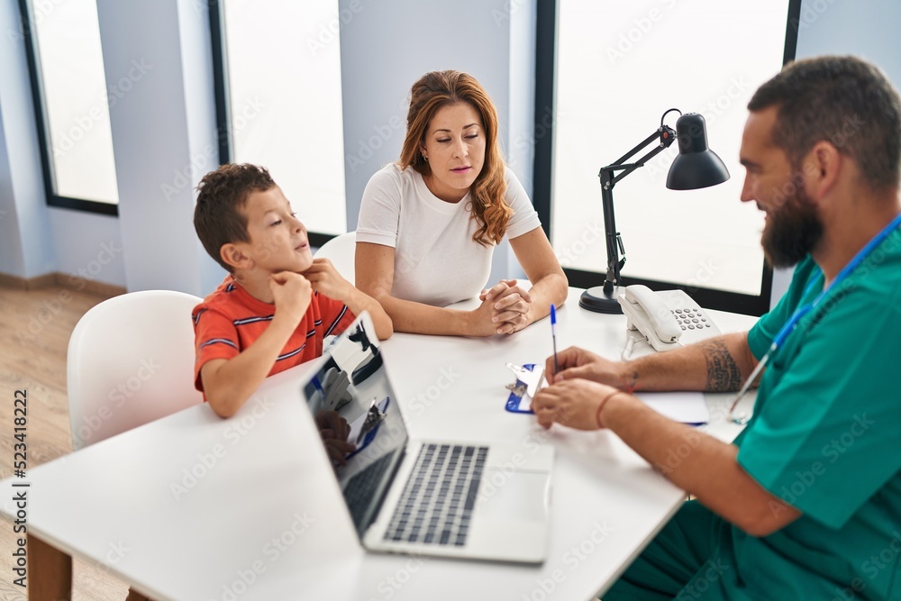 Family having medical consultation at clinic Family having medical consultation at clinic