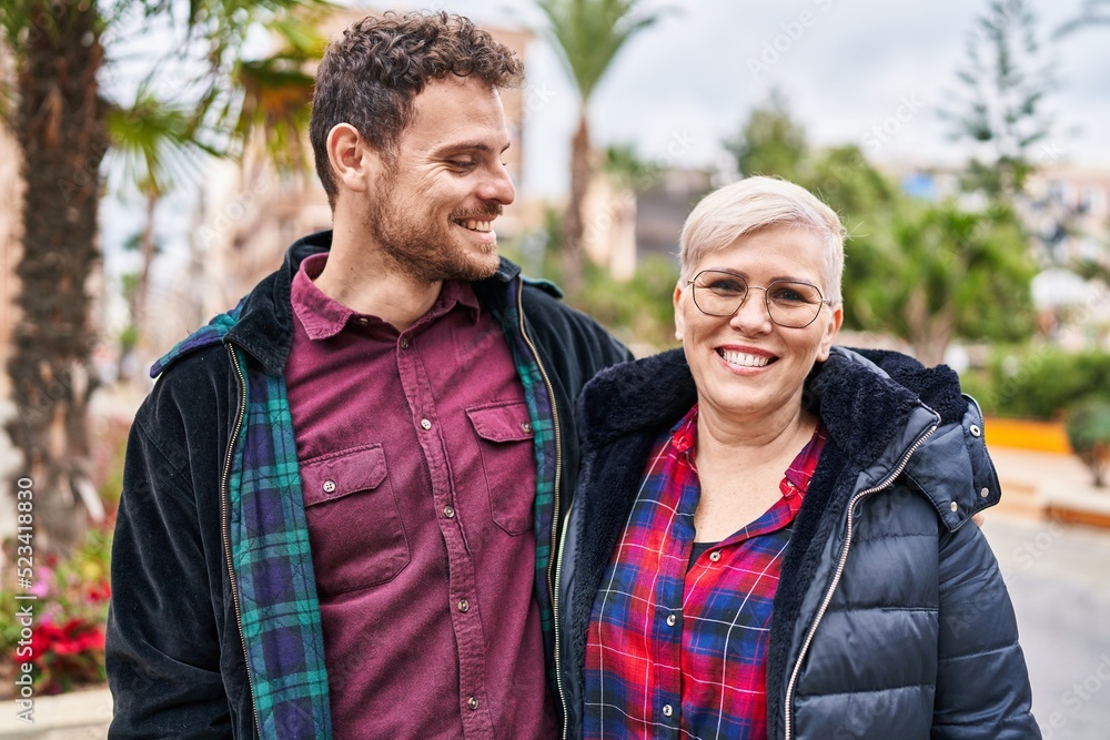 Fototapeta premium Mother and son smiling confident hugging each other at park