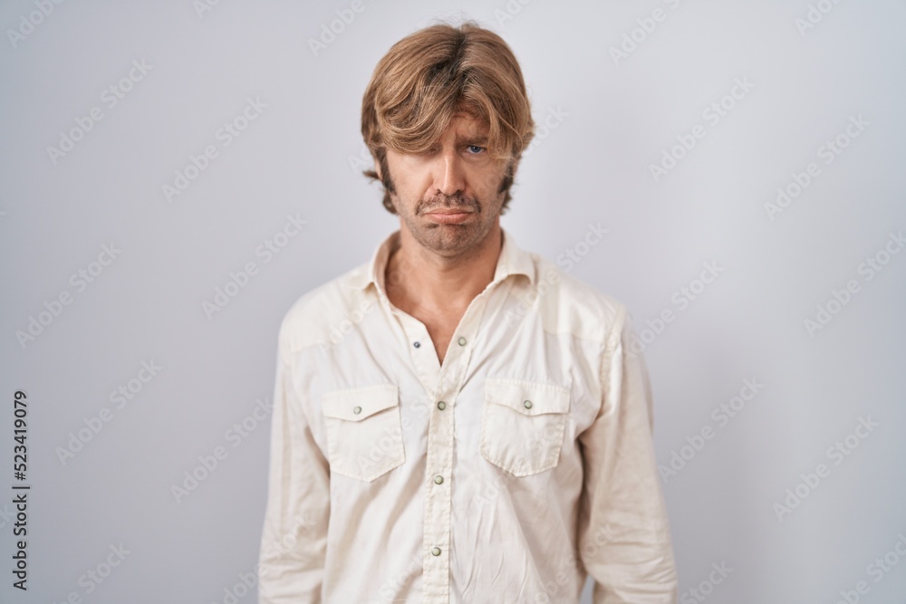 Middle age man standing over isolated background depressed and worry for distress, crying angry and afraid. sad expression. Middle age man standing over isolated background depressed and worry for distress, crying angry and afraid. sad expression.