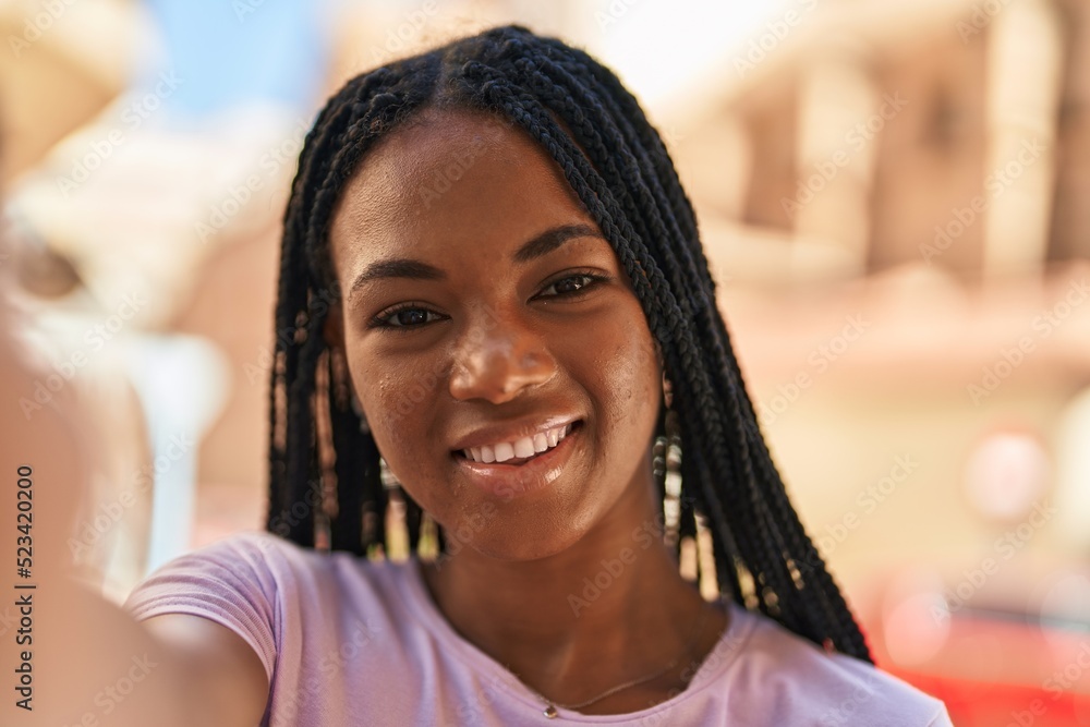 African american woman smiling confident making selfie by the camera at street