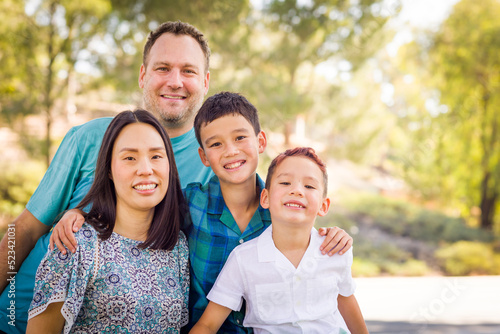 Outdoor portrait of mixed race Chinese and Caucasian family.