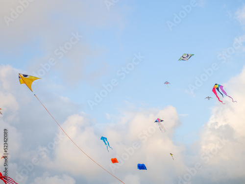 A kite in the sky. Upwards. Wind. Kite Festival. Colorful toys. People fly kites.   Holiday at the resort