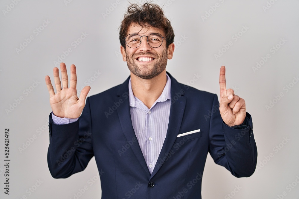 Hispanic business man wearing glasses showing and pointing up with fingers number six while smiling confident and happy. Hispanic business man wearing glasses showing and pointing up with fingers number six while smiling confident and happy.