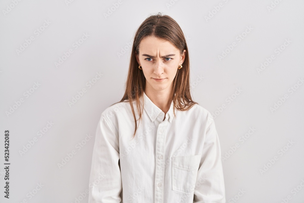 Young caucasian woman standing over isolated background skeptic and nervous, frowning upset because of problem. negative person. Young caucasian woman standing over isolated background skeptic and nervous, frowning upset because of problem. negative person.