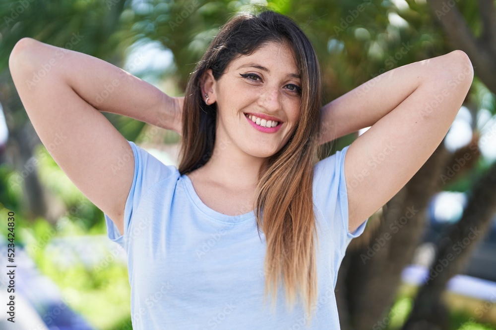 Young hispanic woman smiling confident standing at park