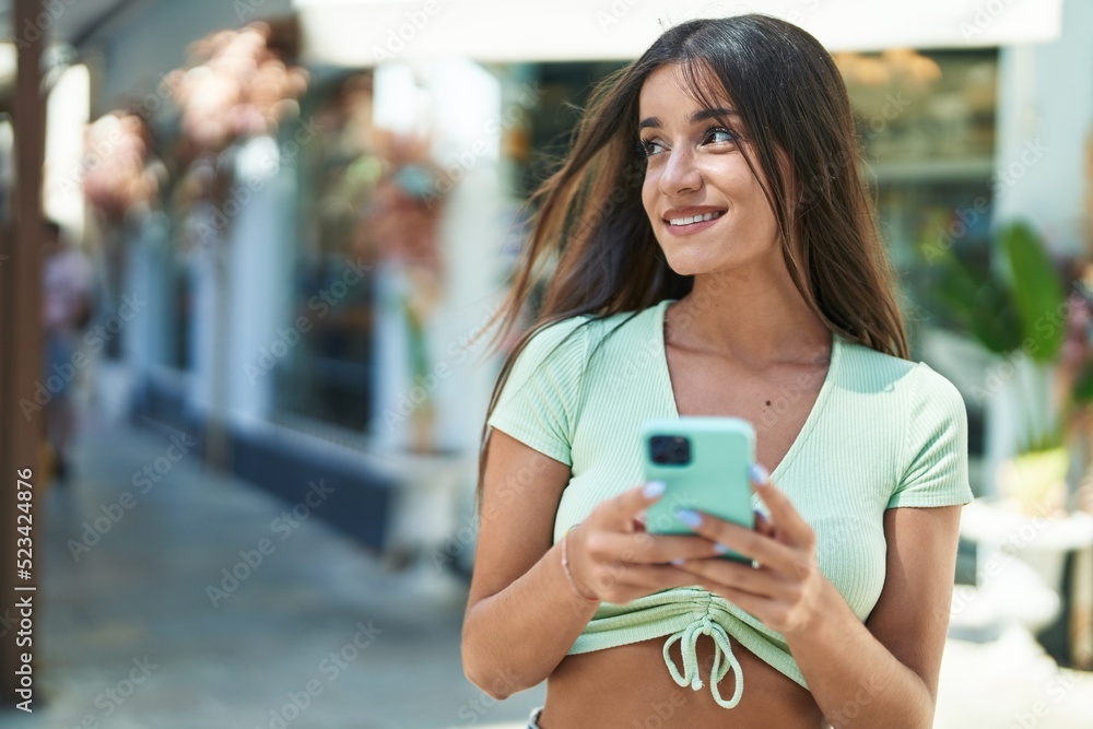 Young beautiful hispanic woman smiling confident using smartphone at street Young beautiful hispanic woman smiling confident using smartphone at street