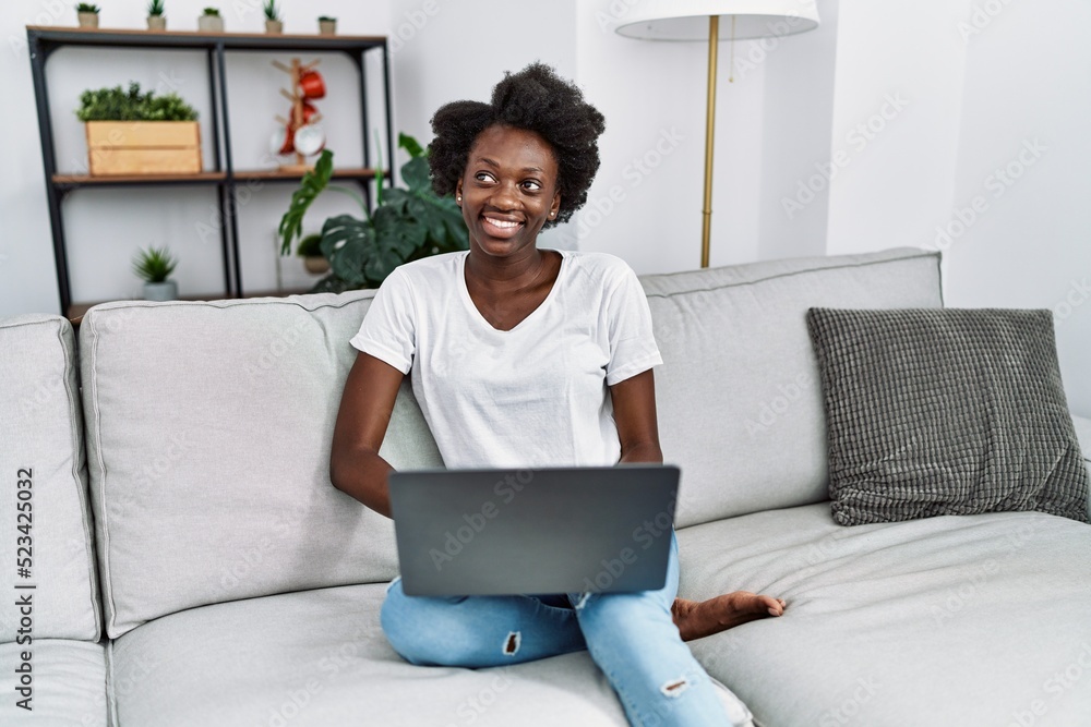 Young african american woman smiling confident using laptop at home Young african american woman smiling confident using laptop at home