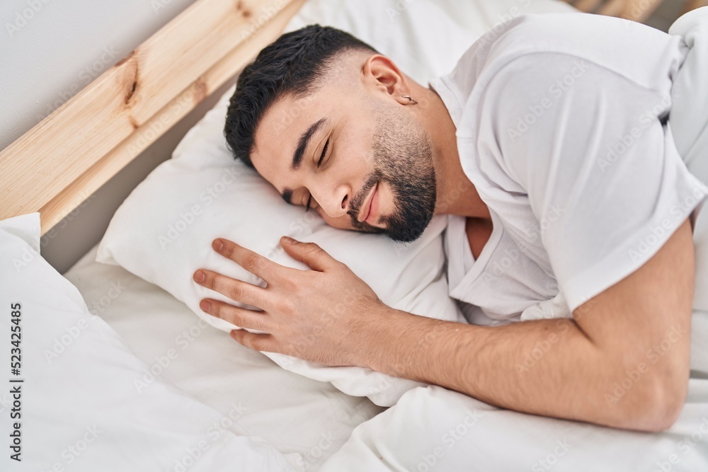 Young arab man lying on bed sleeping at bedroom Young arab man lying on bed sleeping at bedroom