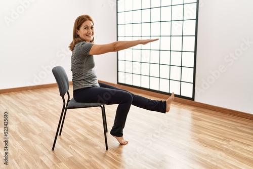 Middle age caucasian woman smiling confident training at sport center