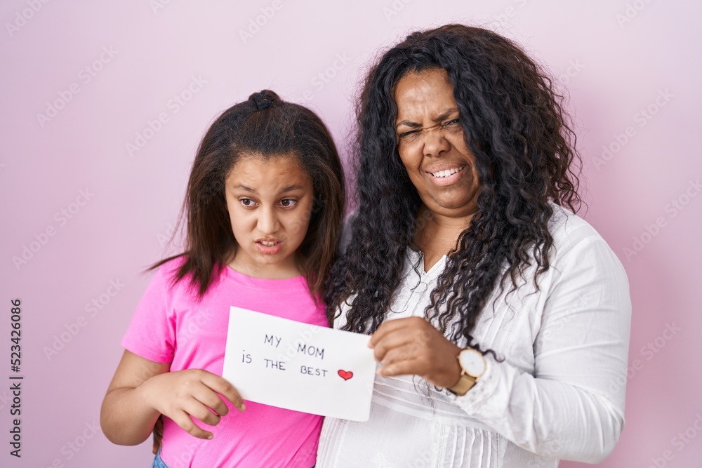Mother and young daughter holding my mom is the best banner clueless and confused expression. doubt concept. Mother and young daughter holding my mom is the best banner clueless and confused expression. doubt concept.