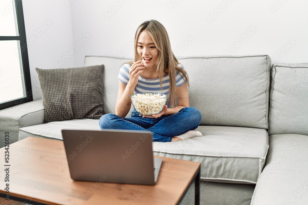 Young chinese woman smiling confident watching movie at home Young chinese woman smiling confident watching movie at home