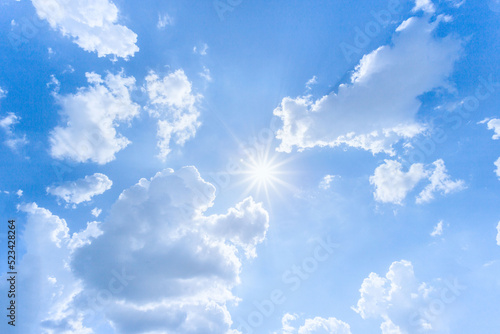 Sunny background, blue sky with white clouds and sun. The natural blue background has a breeze on a bright day in the summer.The sky and clouds are not the same shape as the weather.